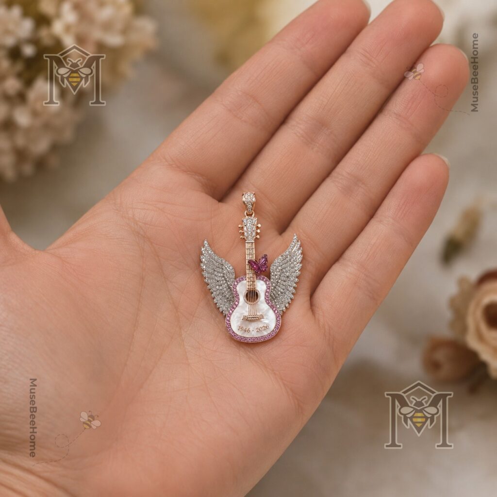Close-up of pink butterfly and engraved 1946-2026 pendant details
