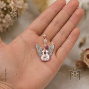 Close-up of pink butterfly and engraved 1946-2026 pendant details