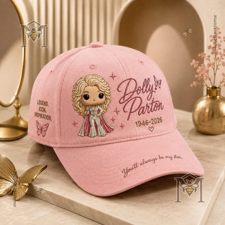 Close-up of the front of the pink Dolly Parton hat cap with a blurred framed photo