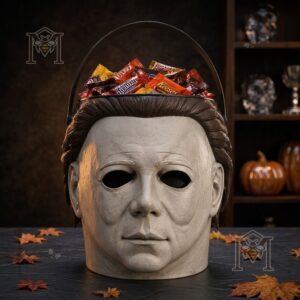 Michael Myers Spooky Trick or Treat Halloween Candy Bucket - full view filled with candy and autumn leaves