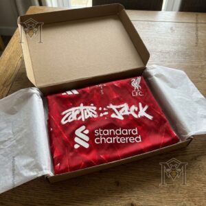 Liverpool Football Club Travis Scott Cactus Jack Home Jersey - full jersey displayed with football accessories