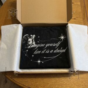 Close view of black shirt with white angelic graphics and lettering